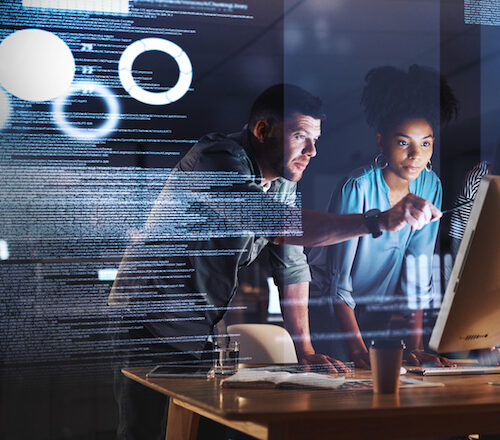 Taking on the late shift with true dedication Shot of a group of programmers working together on a computer code at night